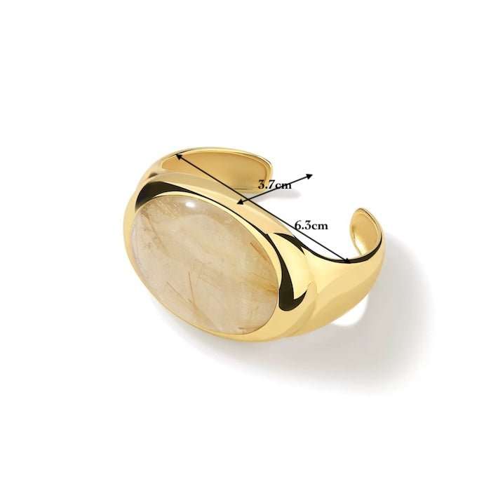Gouden design armband met grote goudgerutileerde kwarts, afmetingen 6.3x3.7 cm