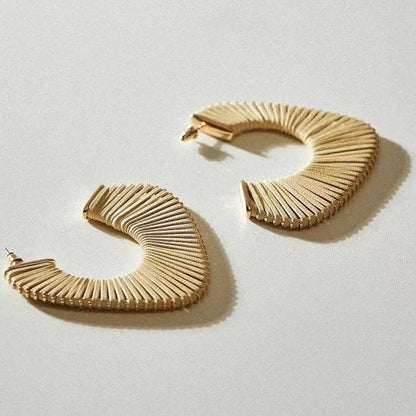 Gouden oorbellen CIRKLA van RAAK.Oorring op witte achtergrond