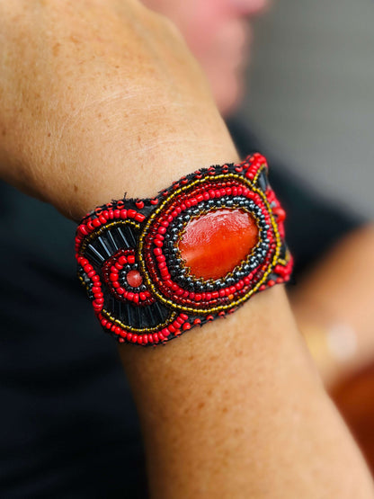 Kleurrijke handgemaakte kralenarmband met grote oranje steen